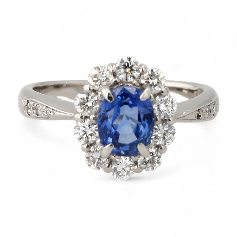 Rings with herkimer diamonds for raw clarity -Platinum Oval Blue Sapphire With Round Diamond Halo Ring